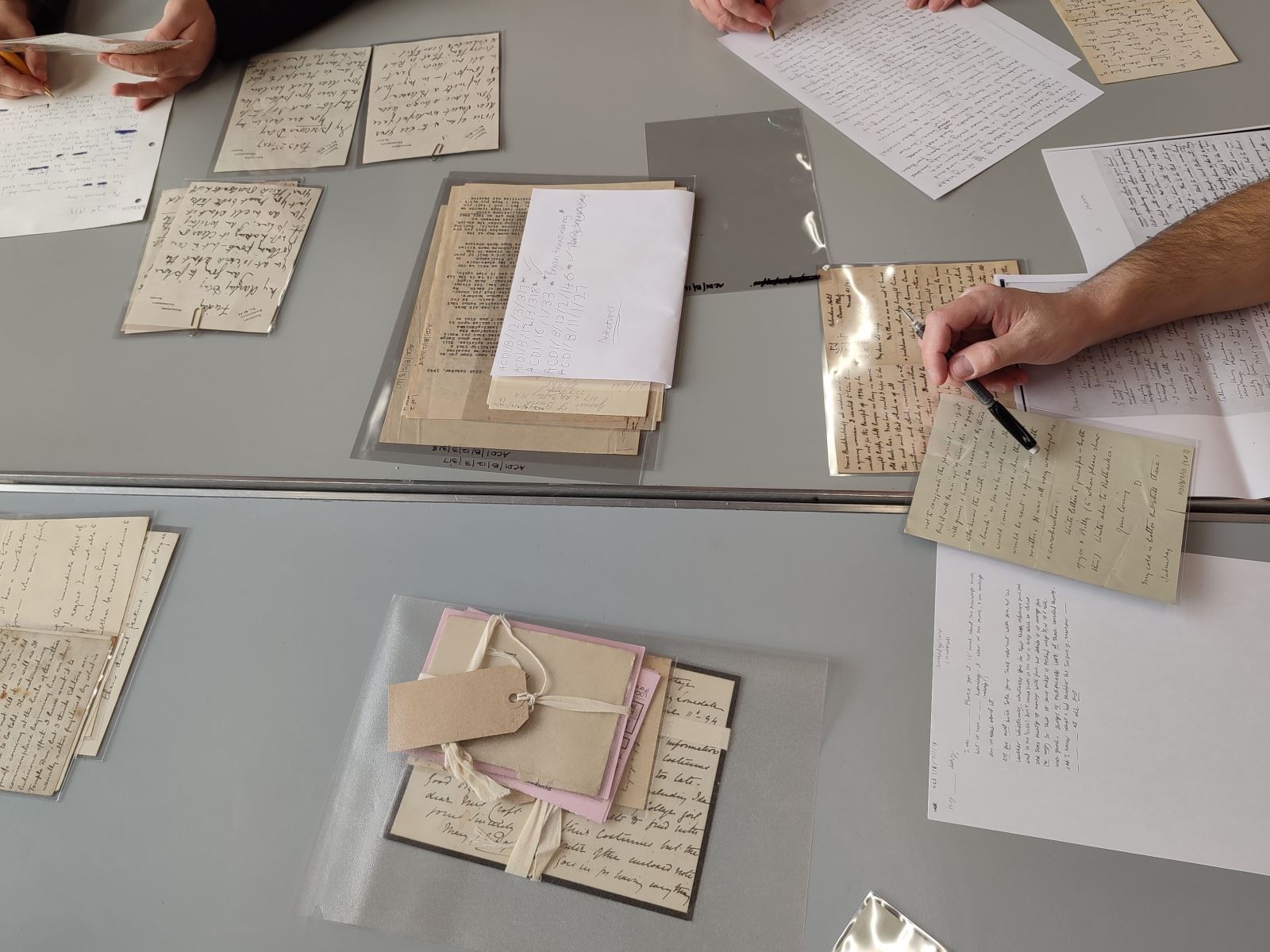 3 People writing out copies of letters from the Conan Doyle Collection